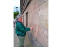 Pat by Bullet holes still in Wall of building from WW II