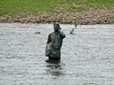 Statue On Cell Phone in River