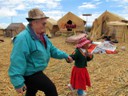Uros child leading Pat to her house