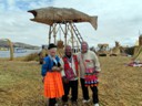 Howard and Pat in traditional Uros clothing (watch tower in background)